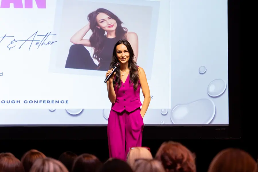 A speaker on stage at the More Than Enough Women's Conference